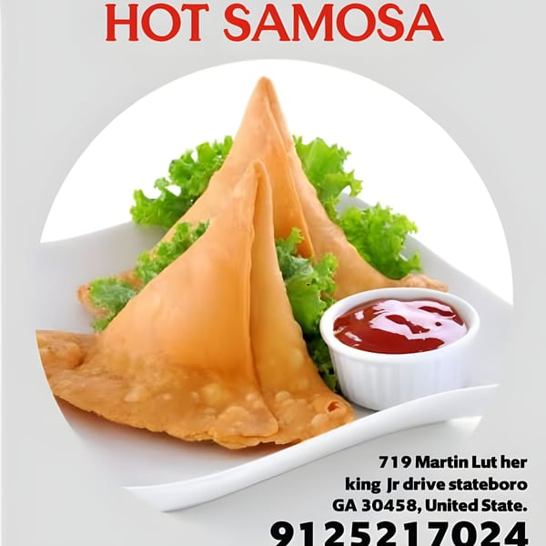 Three golden-brown samosas with lettuce and a side of red sauce on a white plate.
